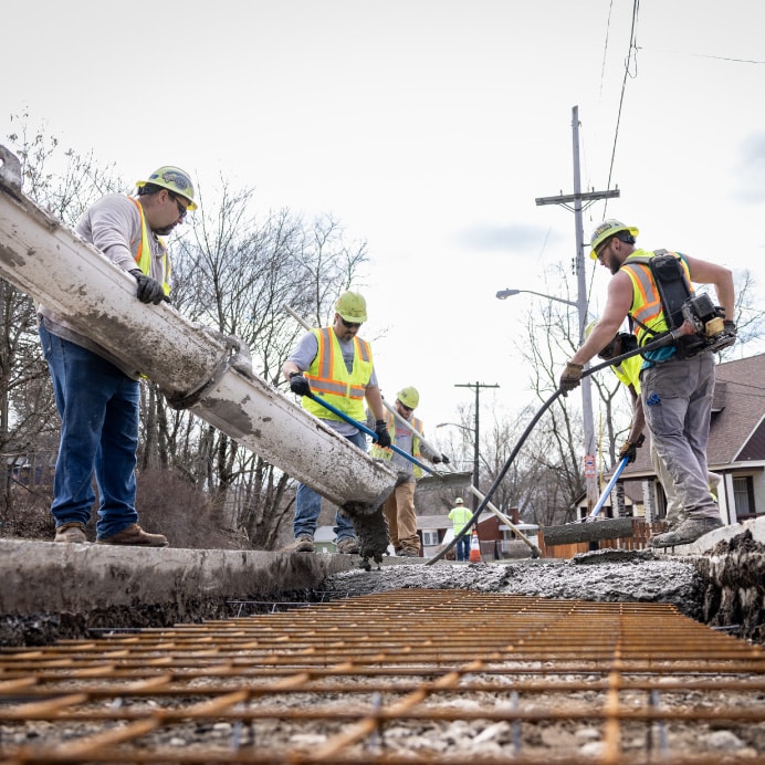 construction workers pouring cement