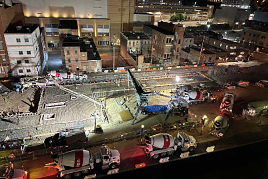 overhead view of castle builders supply team pouring concrete at a job site